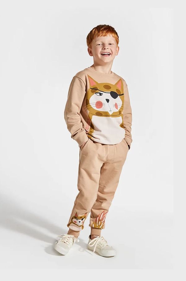 Coccodrillo Dječji pamučni donji dio trenirke Coccodrillo boja: bež, s tiskom, LICENCE BOY KOCIA SZAJKA