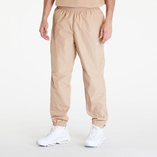 Nike Hlače Nike x NOCTA Woven Track Pants Hemp/ Sanddrift XS