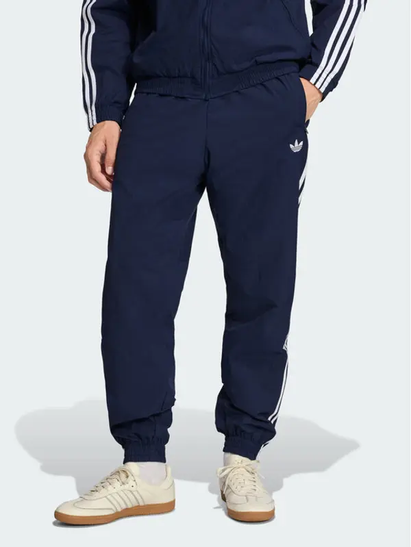 Adidas adidas Donji dio trenerke Firebird Woven KE1370 Tamnoplava Regular Fit
