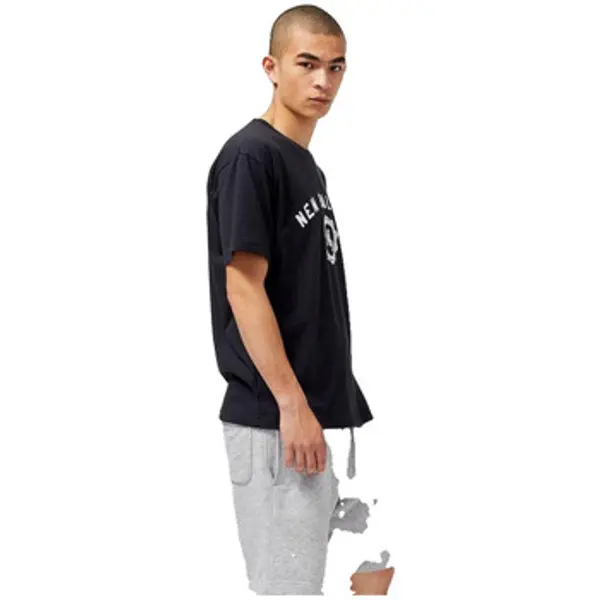 New Balance New Balance  Majice kratkih rukava T-shirt  L noir col rond et manches courtes  New Balance